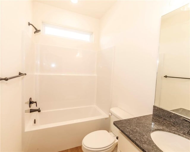 bathroom featuring vanity, washtub / shower combination, and toilet