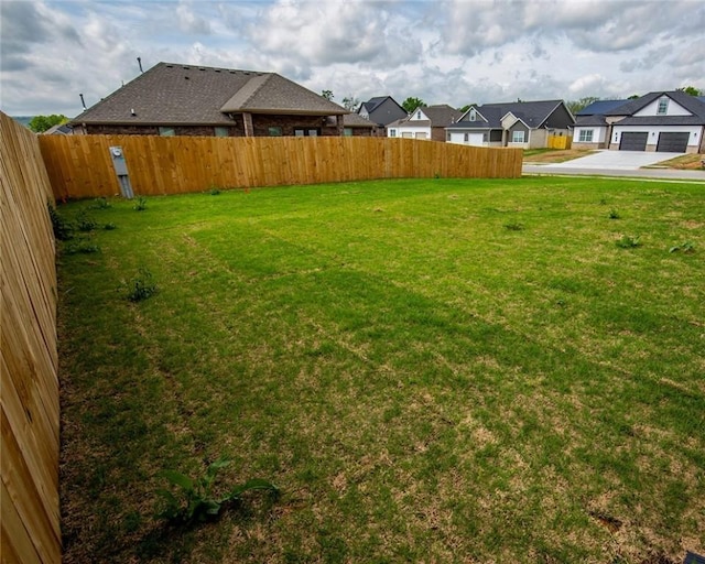 view of yard with fence and a residential view