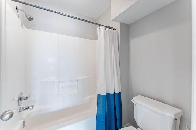 bathroom featuring shower / bathtub combination with curtain and toilet