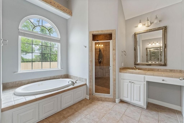 full bath with a garden tub, a stall shower, vaulted ceiling, and vanity