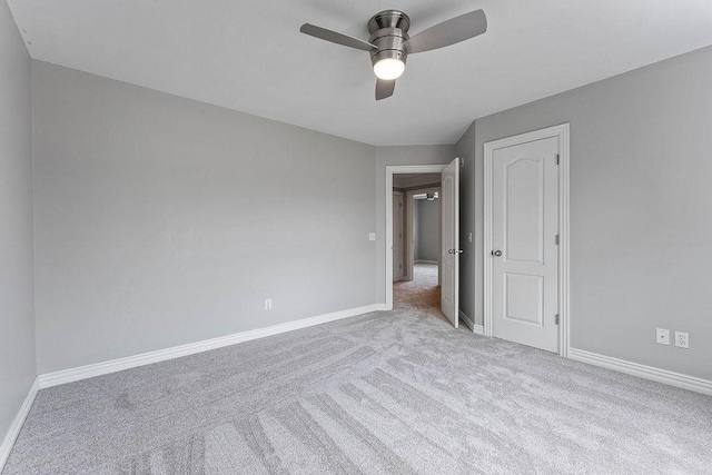 unfurnished bedroom with carpet floors, baseboards, and a ceiling fan