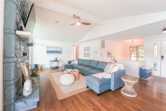 living area featuring visible vents, wood finished floors, a fireplace, ceiling fan, and lofted ceiling with beams