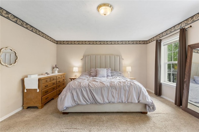 bedroom featuring carpet floors and baseboards