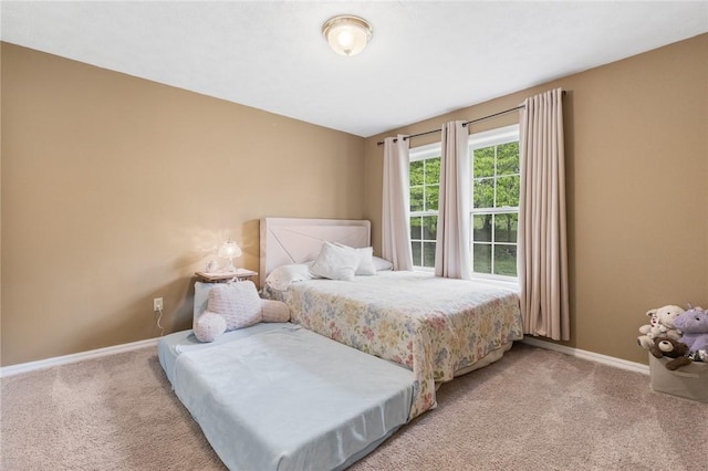 carpeted bedroom with baseboards