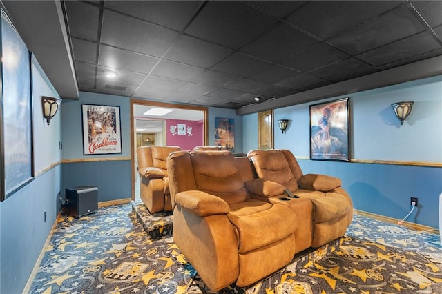 home theater room with baseboards, carpet flooring, and a paneled ceiling