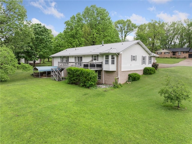rear view of house featuring a lawn, brick siding, metal roof, and a deck