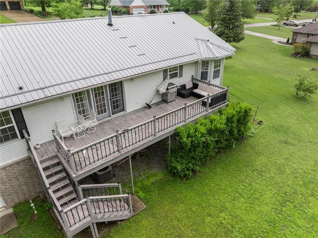rear view of house with a lawn, cooling unit, a wooden deck, and metal roof