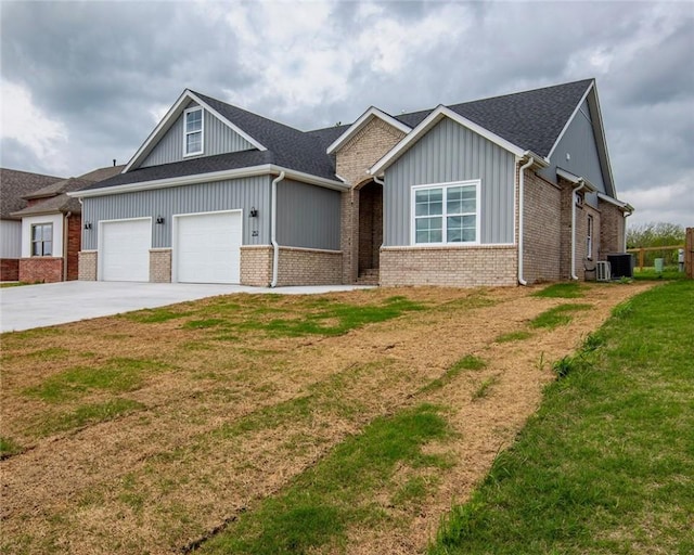 view of front of property featuring board and batten siding, a front yard, brick siding, concrete driveway, and an attached garage