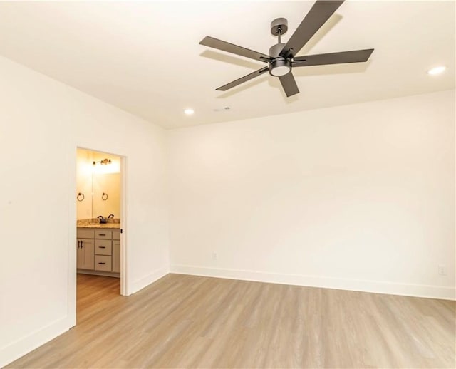 unfurnished room featuring baseboards, light wood finished floors, and ceiling fan