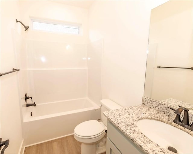 bathroom featuring toilet, shower / bath combination, wood finished floors, and vanity