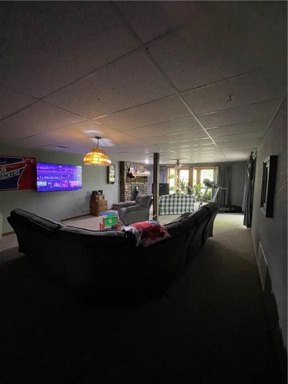 playroom with carpet floors and a drop ceiling