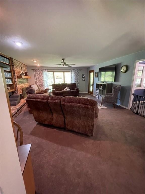 living room featuring a brick fireplace, plenty of natural light, and carpet
