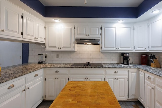 1 Panbury Ln, Bella Vista, AR 72715 - kitchen with under cabinet range hood, black electric stovetop, wooden counters, and white cabinetry