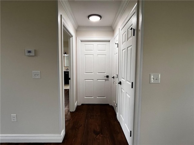 corridor with ornamental molding and dark wood-type flooring