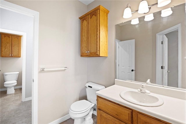 2314 W 7th St, Russellville, AR 72801 - bathroom featuring vanity, baseboards, and toilet