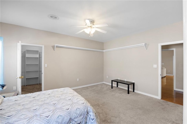 2314 W 7th St, Russellville, AR 72801 - carpeted bedroom with baseboards, a ceiling fan, and a walk in closet