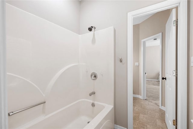 2314 W 7th St, Russellville, AR 72801 - full bathroom with stone tile floors, baseboards, and shower / tub combination