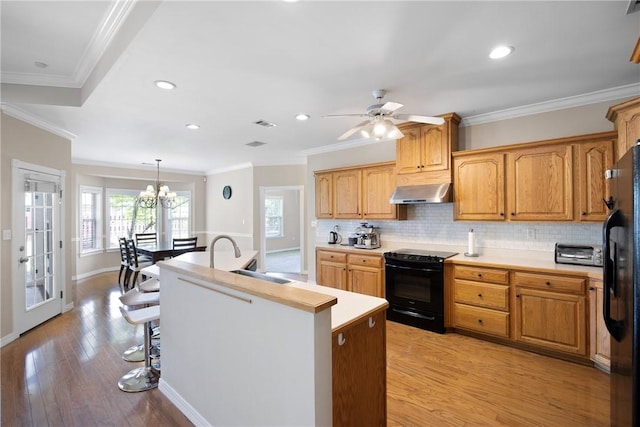 2314 W 7th St, Russellville, AR 72801 - kitchen with a sink, ventilation hood, backsplash, and black appliances