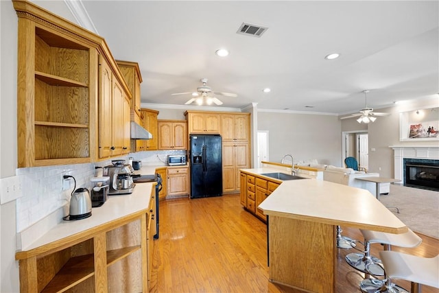 2314 W 7th St, Russellville, AR 72801 - kitchen featuring ceiling fan, range with electric cooktop, a sink, stainless steel microwave, and black refrigerator with ice dispenser