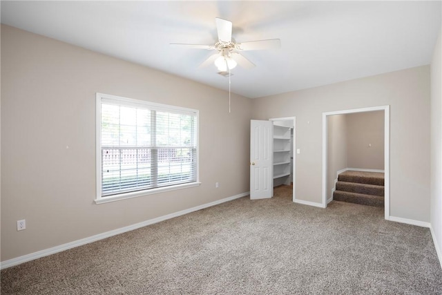 2314 W 7th St, Russellville, AR 72801 - unfurnished bedroom featuring carpet floors, a ceiling fan, baseboards, a spacious closet, and a closet