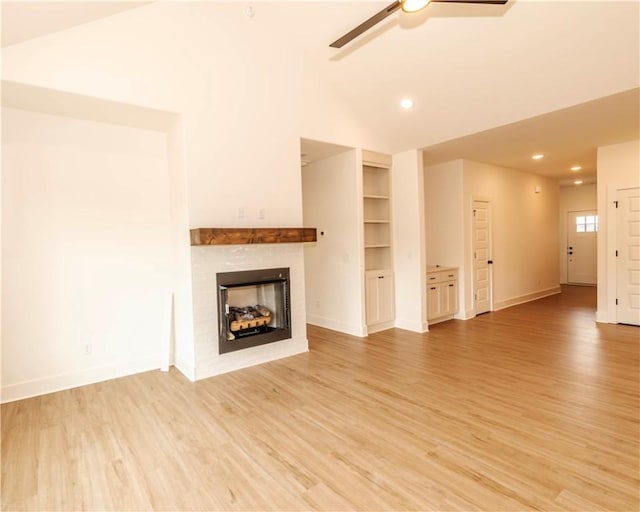 unfurnished living room with ceiling fan, a tiled fireplace, baseboards, light wood finished floors, and recessed lighting