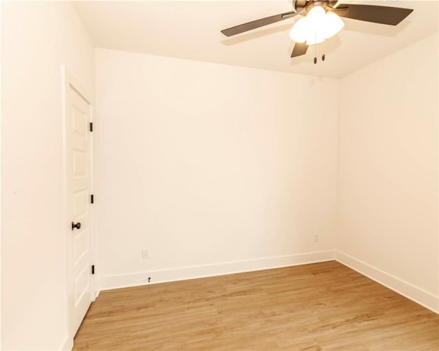 empty room with baseboards, ceiling fan, and light wood-style flooring