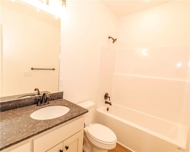bathroom featuring toilet, bathing tub / shower combination, and vanity