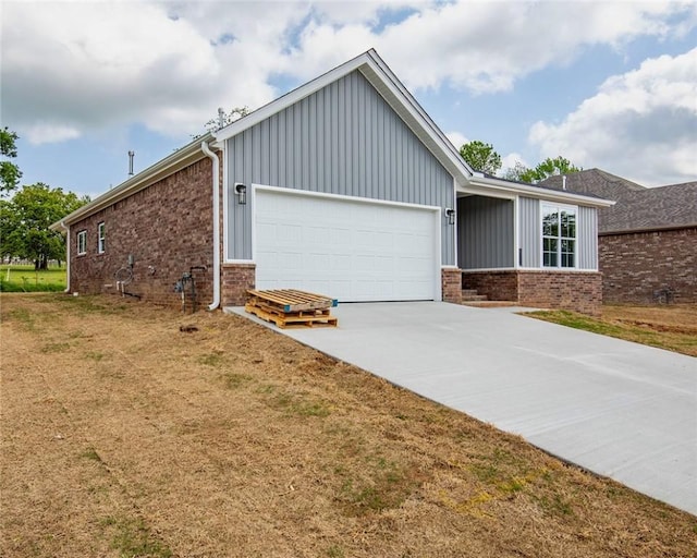 view of property exterior with a garage, board and batten siding, and brick siding