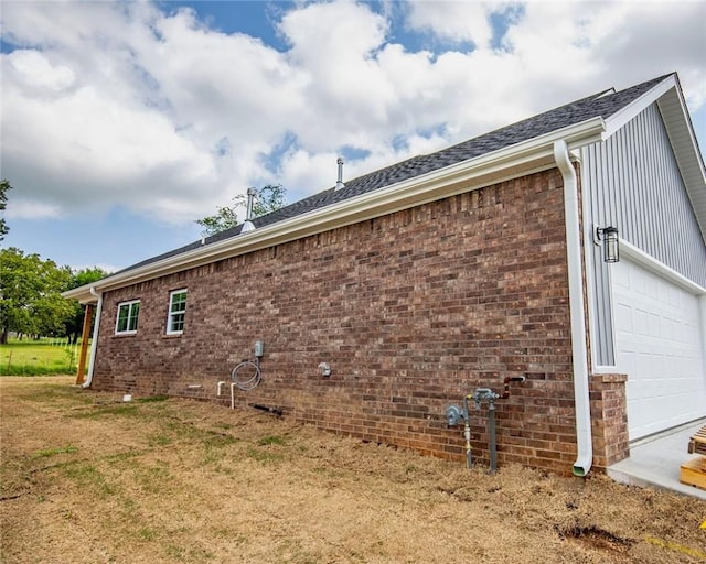 view of side of home with brick siding