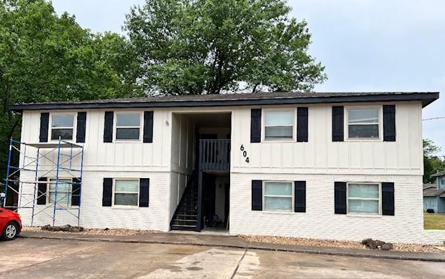raised ranch with board and batten siding and stairs