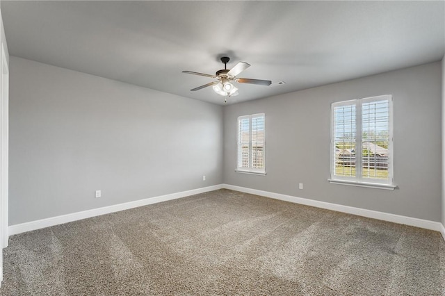 spare room featuring baseboards, a ceiling fan, and carpet floors