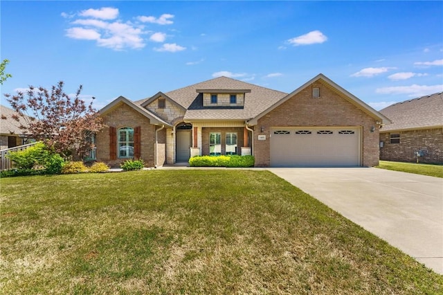 view of front of home with an attached garage, driveway, a front lawn, and brick siding