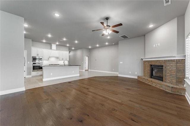 unfurnished living room featuring recessed lighting, ceiling fan, visible vents, and baseboards