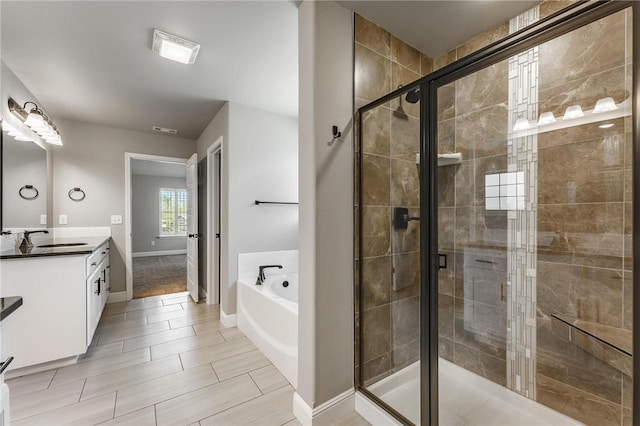 bathroom with vanity, baseboards, visible vents, a bath, and a stall shower