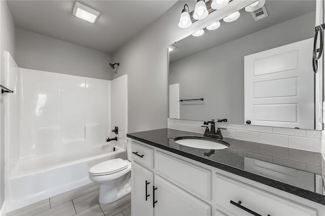 full bathroom featuring visible vents, shower / tub combination, vanity, tile patterned floors, and toilet