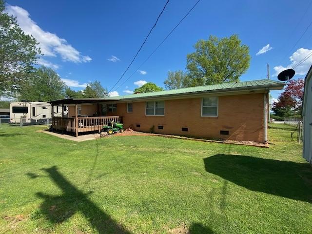 503 Skyline Dr, Harrison, AR 72601 - rear view of property featuring crawl space, a lawn, a deck, metal roof, and brick siding
