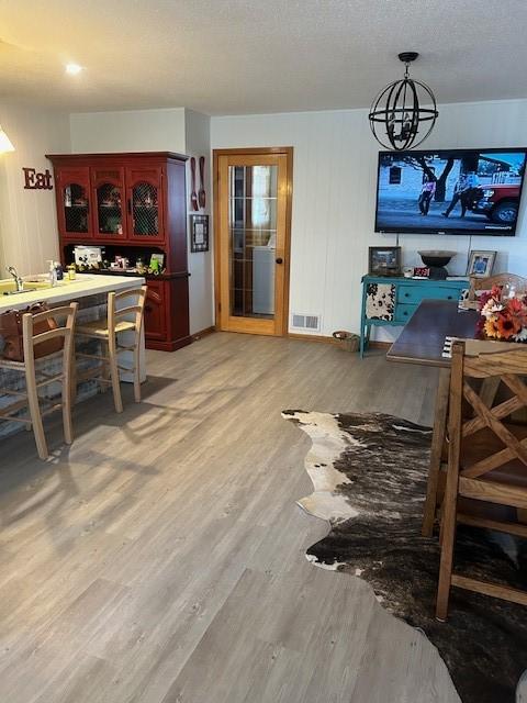 dining space with visible vents and light wood-style floors