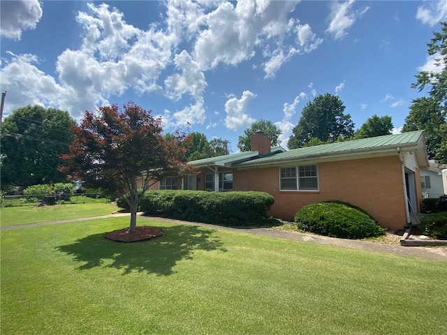 503 Skyline Dr, Harrison, AR 72601 - view of side of home featuring a chimney, brick siding, a lawn, and metal roof