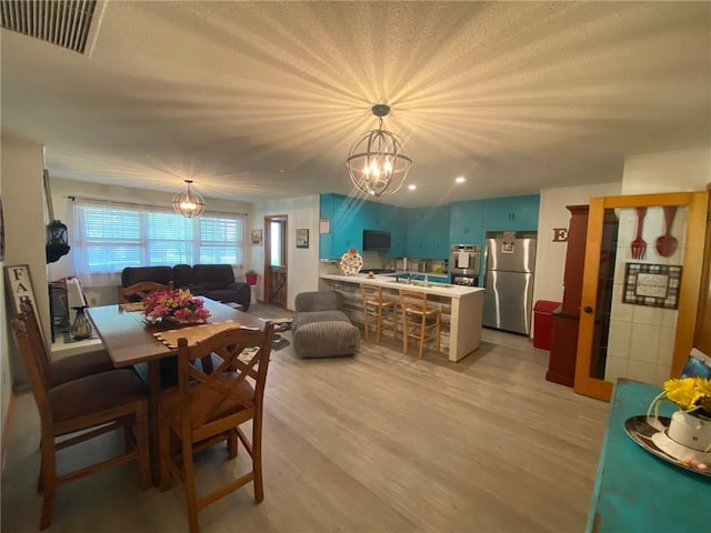 503 Skyline Dr, Harrison, AR 72601 - dining space with a chandelier and light wood-style floors