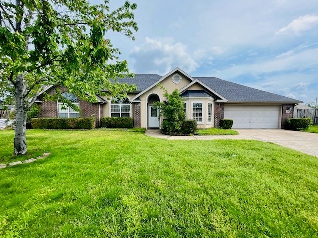 single story home featuring a garage, driveway, a front lawn, and brick siding
