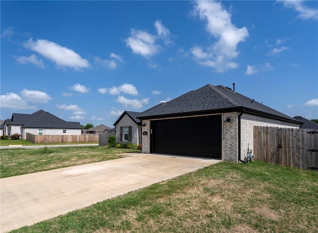view of front of house featuring fence, an attached garage, a front yard, and brick siding