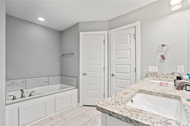 bathroom featuring a sink, double vanity, a bath, and marble finish floor