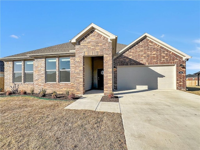 ranch-style home featuring a garage, driveway, roof with shingles, and brick siding
