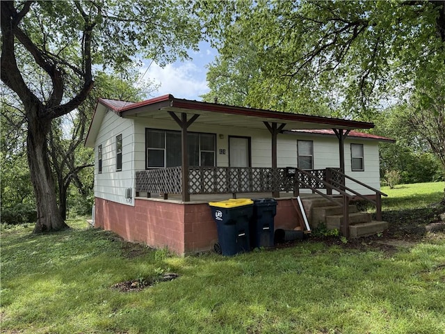 view of front of home with a porch and a front yard