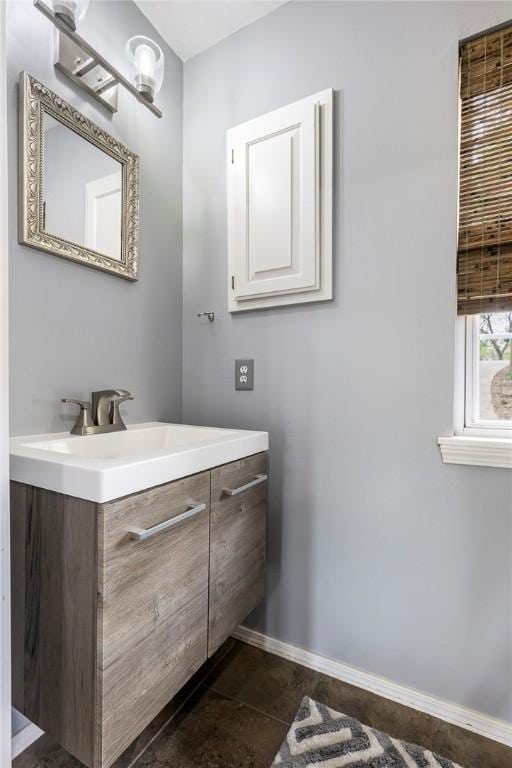 bathroom with baseboards, tile patterned flooring, and vanity