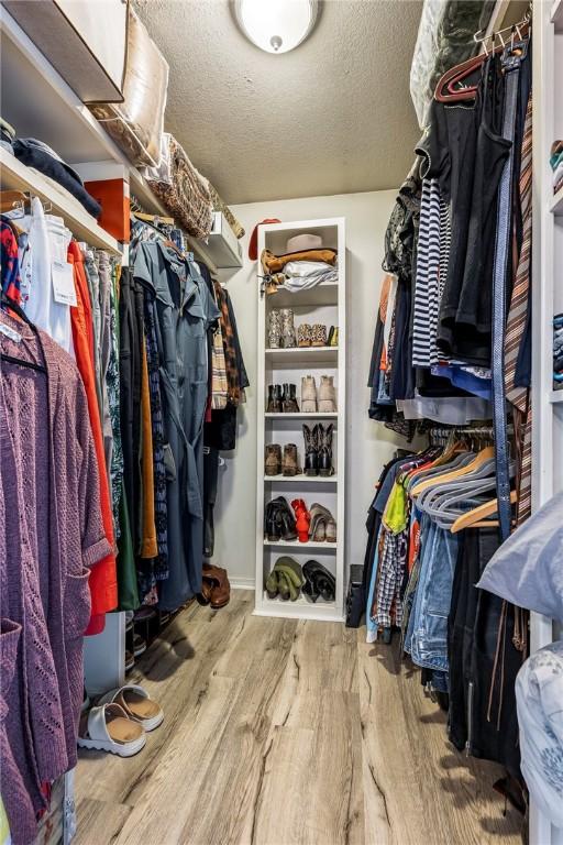 spacious closet with wood finished floors