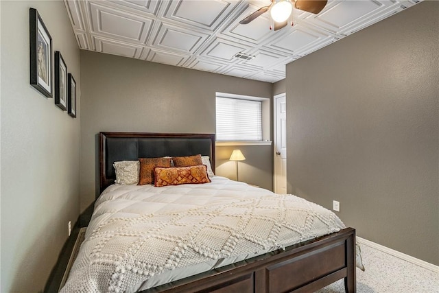 carpeted bedroom featuring baseboards, a ceiling fan, an ornate ceiling, and visible vents