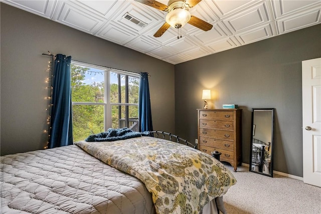 bedroom featuring light colored carpet, a ceiling fan, and an ornate ceiling