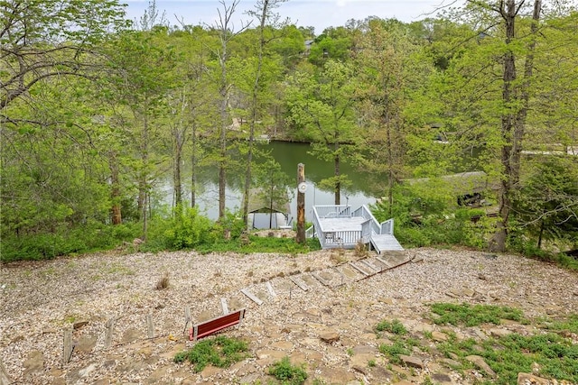view of dock featuring a water view and a forest view
