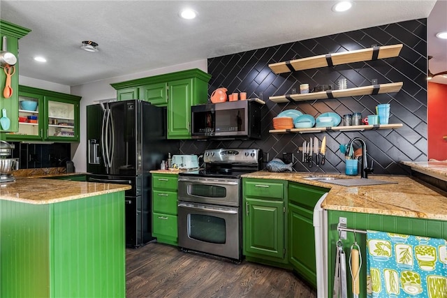 kitchen featuring decorative backsplash, a sink, dark wood finished floors, appliances with stainless steel finishes, and green cabinets